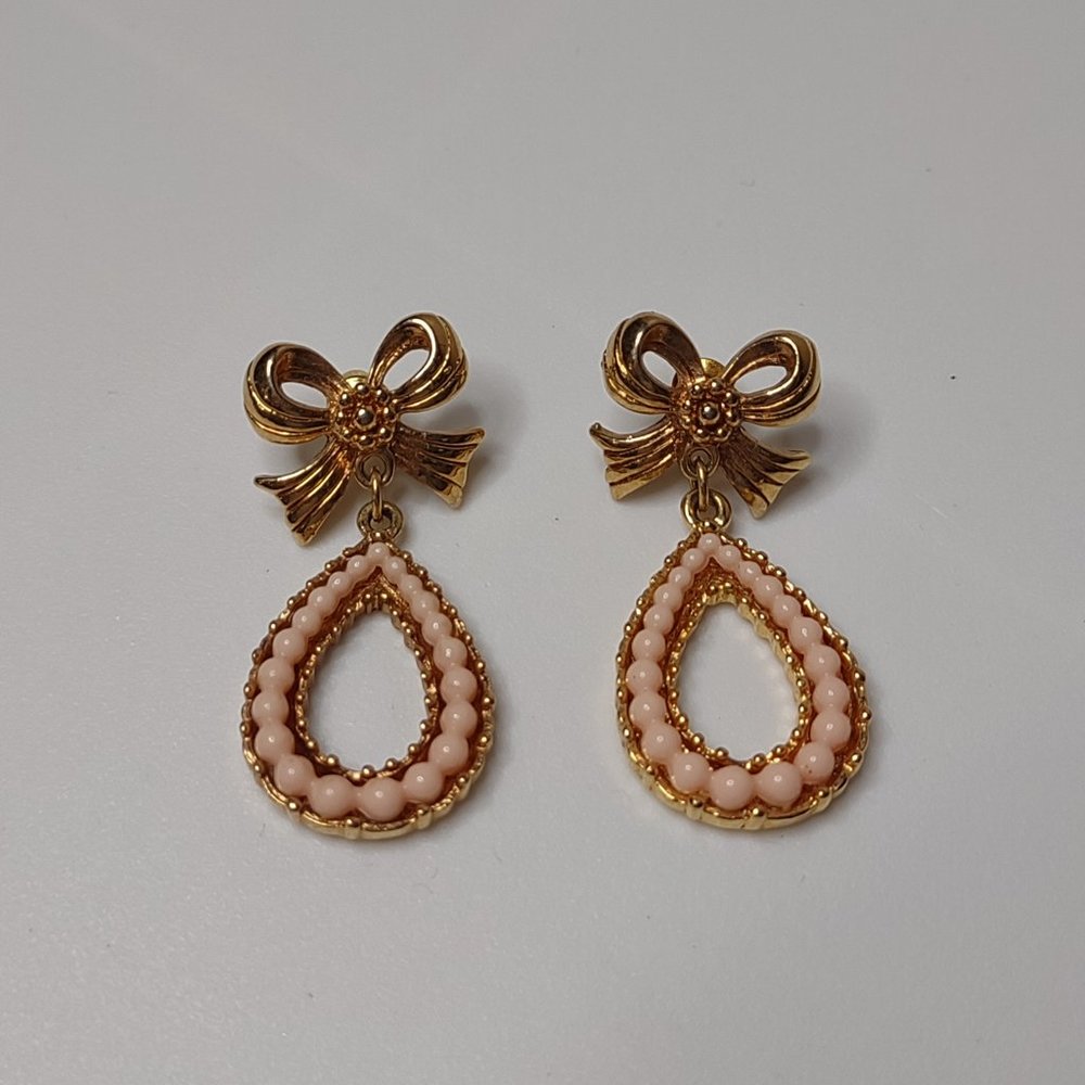 Gold Tone And Pink Teardrop Shaped Dangle Earrings With Bow